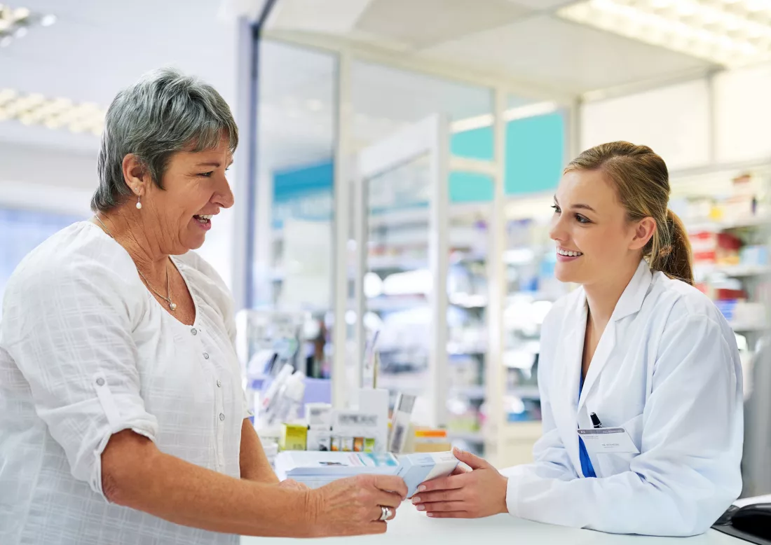 reviewing-instructions-with-her-customer-shot-young-pharmacist-assisting-customer