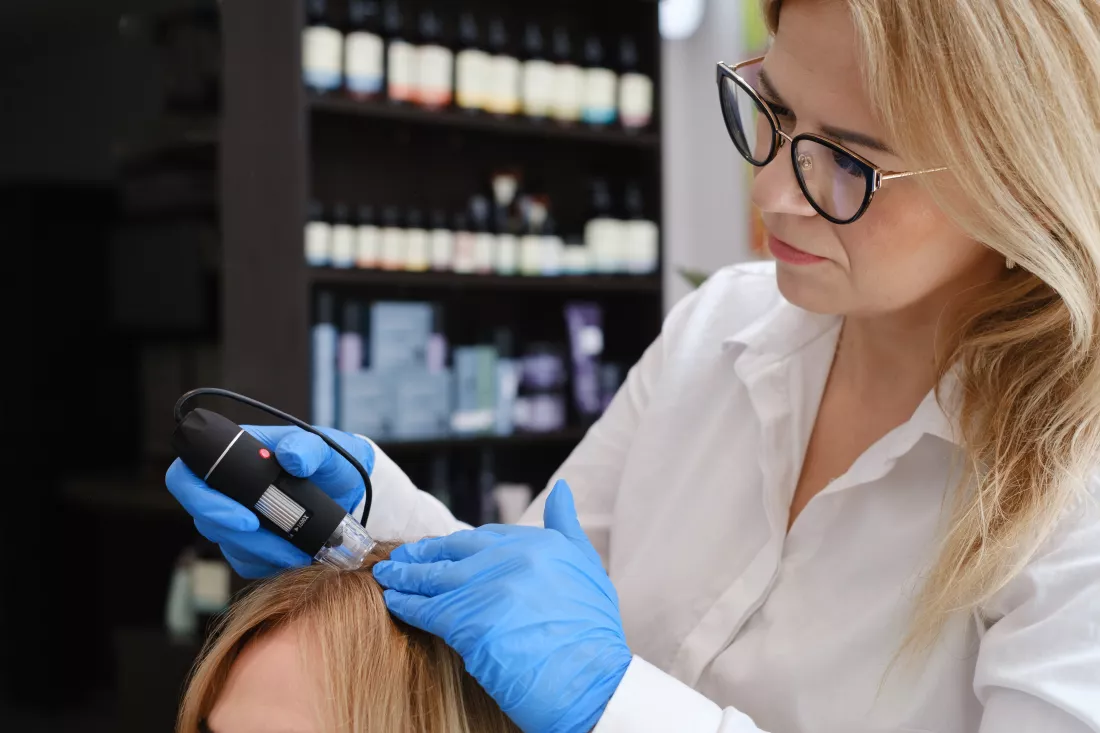 doctor-examines-head-skin-young-girl-with-special-dermatology-equipment-system-hairloss