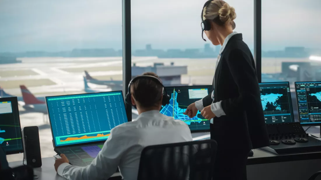 man-woman-control-room-with-plane-background